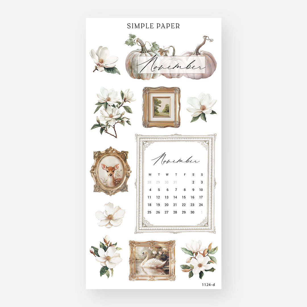 A sheet of paper with a 'November' theme, featuring various decorative stickers such as flowers, a pumpkin, and a framed picture, designed for use in a planner.