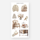 Sheet of decorative stickers with sweaters, blankets, tea sets, magnolia flowers, and vintage furniture on a white background