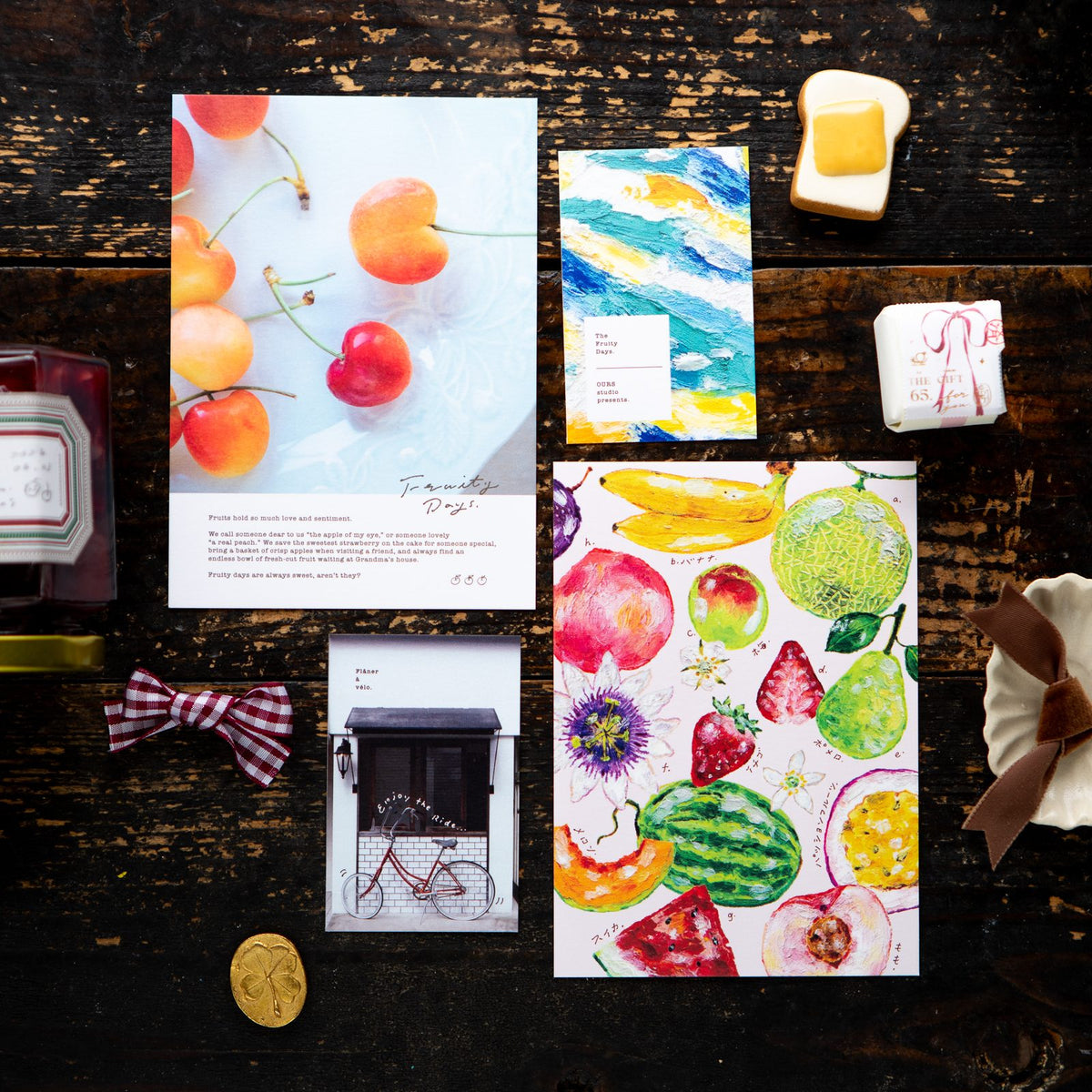 The four postcards and minicards from the 2027 set laid out together. Photo: OURS Studio