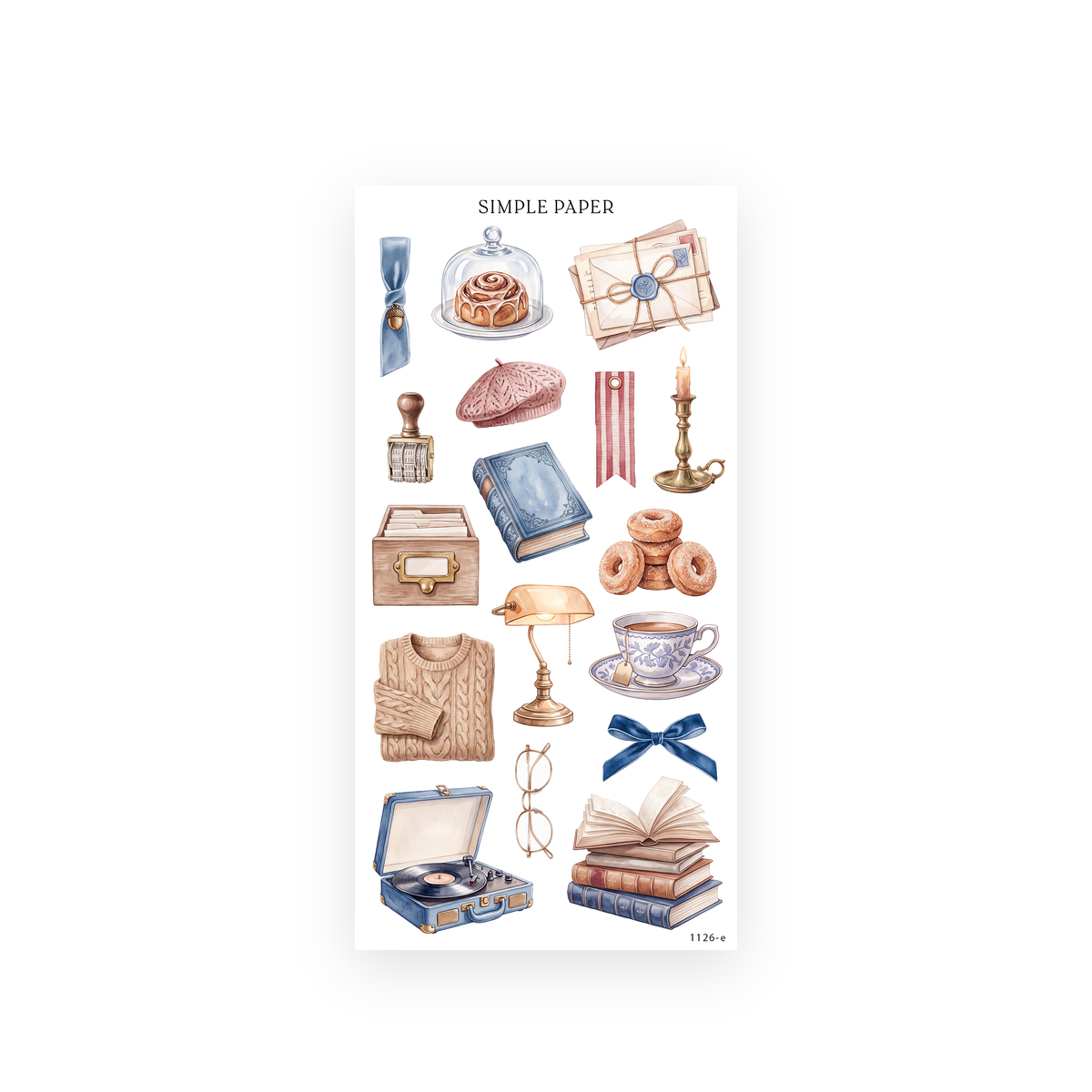 Watercolor cinnamon roll under a glass cloche, cable-knit sweater, record player, desk lamp, teacup and stacked books