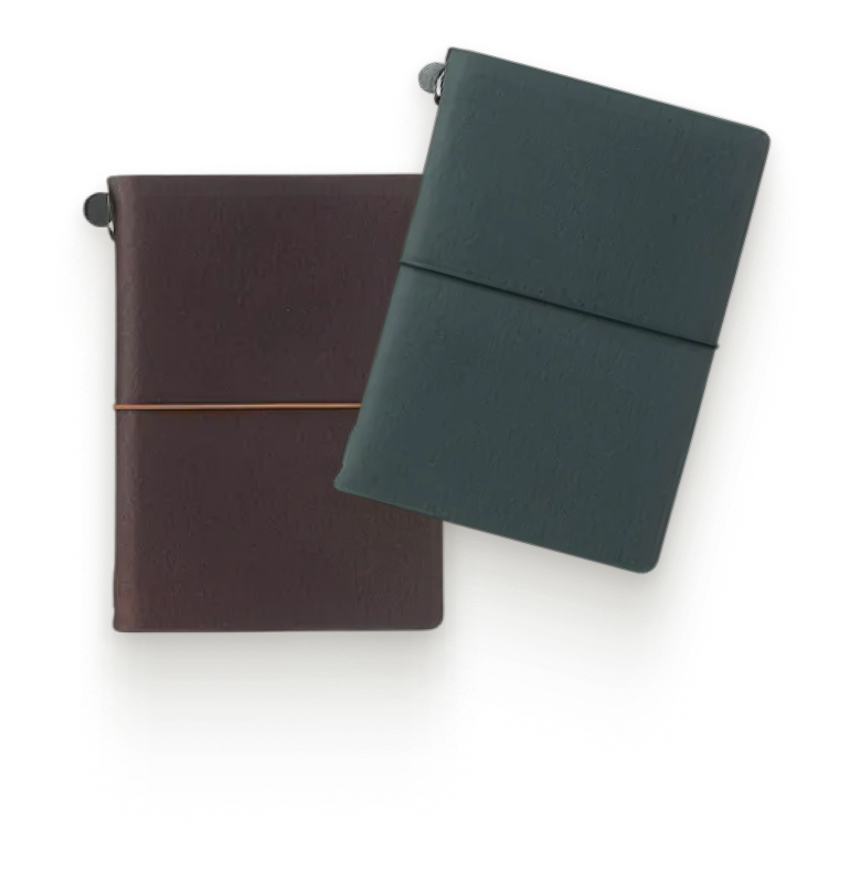 Two Traveler's Company leather notebooks, brown and green