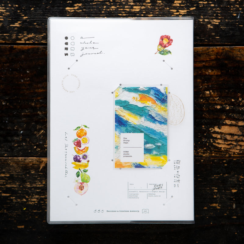 OURS Studio 2027 journal, The Reunion, with the painted minicard in its cover slot. Photo: OURS Studio